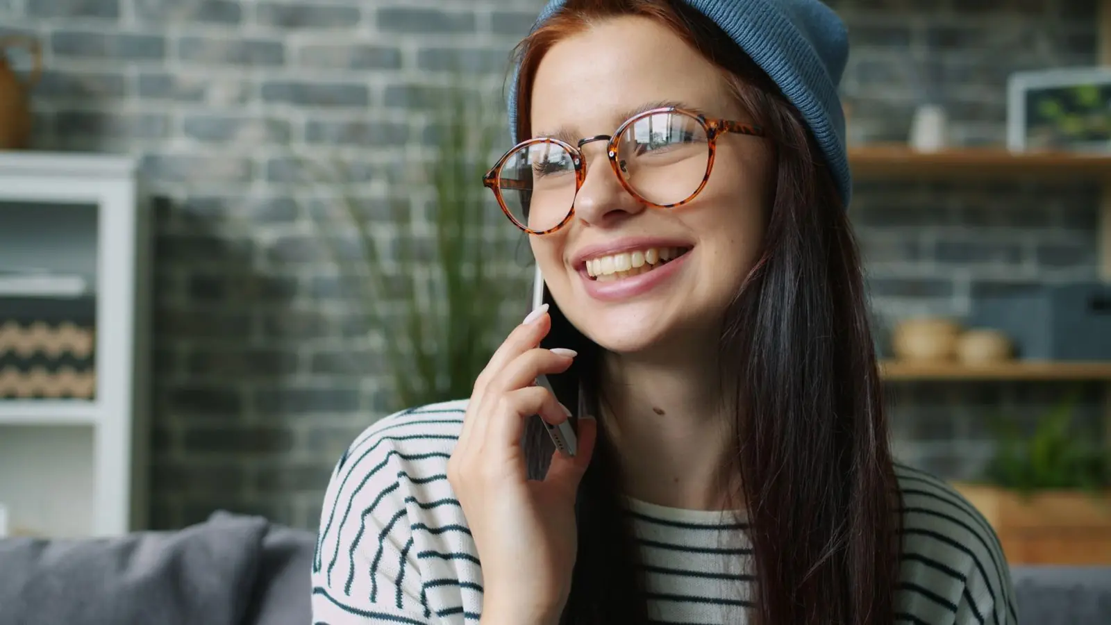 A smiling woman answering a phone call